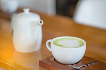 white coffee cup and tea jar