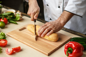  Mature man professional chef cooking meal indoors