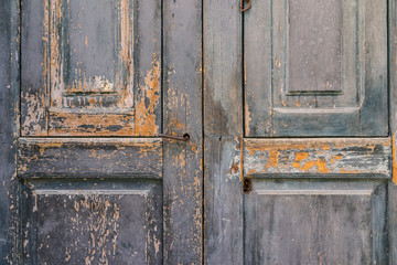 aged vintage peeling paint barn wooden door texture as background