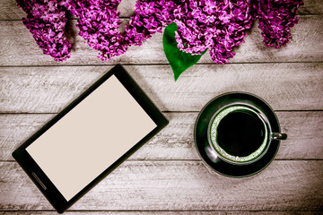 workspace with tablet and coffee cup. lilac on wooden background. top view with copy space.celebration template concept.
