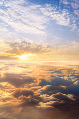 Naklejka premium sunset clouds sky skyscape. view from the window of an airplane flying in the clouds, top view clouds like the sea of clouds sky background