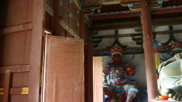 Chinese immortals Buddhist Vajra sculpture & pregnant Maitreya in carved beams painted buildings,ancient door.