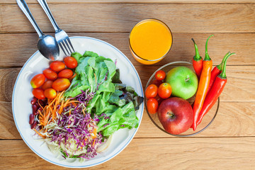 Healthy concept with mixed fruits and vegetables on wooden background