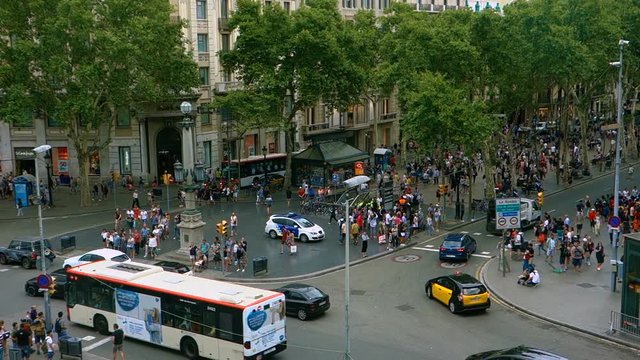 Crowd of anonymous people walking on the Rambla of Barcelona