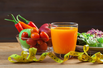 Healthy concept with mixed fruits and vegetables on wooden background