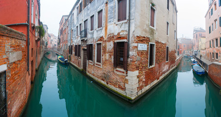 Fototapeta na wymiar Vintage red brick house and gondola in grand canal, Venice.