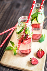Detox water infused with fruits. Summer water fruit on rustic background