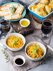 Lunch with curry pasta noodles in bowls and vegetables with turmeric