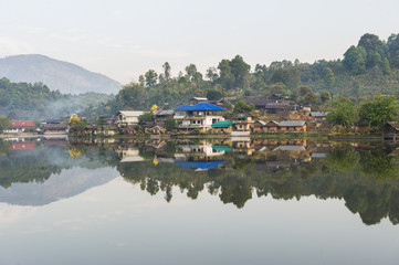 Tribal high hill village locate at the river bank with water reflection, sun rise warm tone, peace mind, fresh