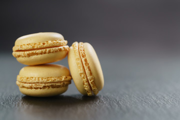 three lemon macarons on slate board