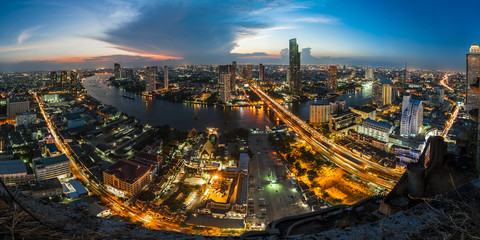 Aerial view at sunset landscape of Bangkok city skyline with very long bridge cross the river