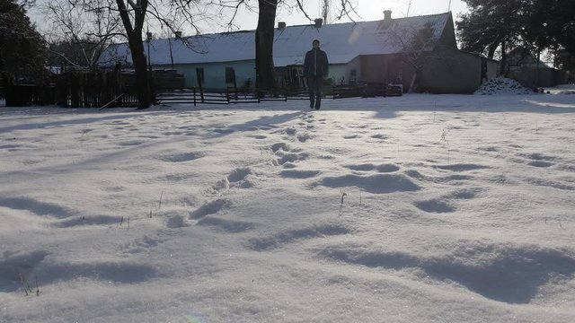 A man walks through the snow in the winter. The countryside in winter
