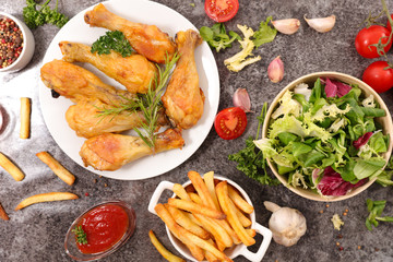 grilled chicken leg with french fries and salad