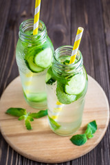 Detox water infused with mint and cucumber. Summer water fruit on rustic background