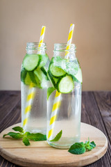 Detox water infused with mint and cucumber. Summer water fruit on rustic background