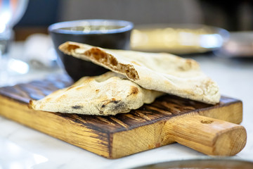 The different slices of bread with grains are on the Board and olive oil.