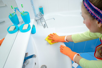 Cleaning - cleaning bathroom sink and faucet with detergent in rubber gloves with sponge - housework, spring cleaning concept