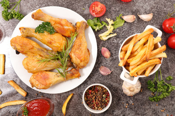 grilled chicken leg with french fries and salad