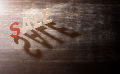 SALE word made from wooden letters on wood