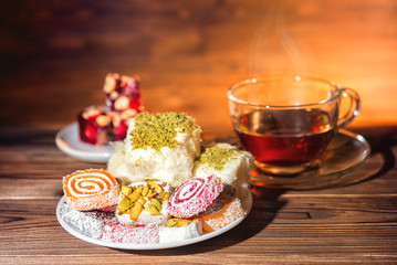 still life with east candy and cup of tea, close up