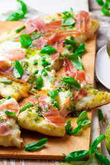 PEA PROSCIUTTO SPRING PIZZA . Top view. selective focus