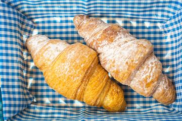 Fresh French croissants in basket