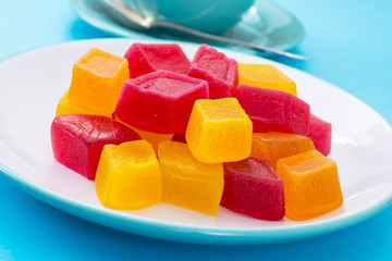 Marmalade on plate and tea in mug, blue background