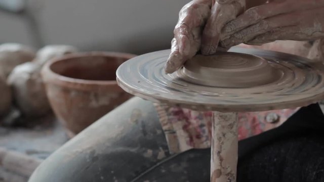 Working behind a potter's wheel
