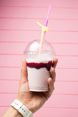 Shake in plastic cup in hand