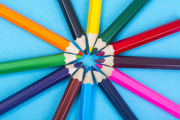 Stationery: colored pencils on blue background. 