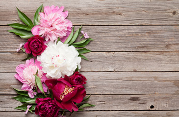 Garden peony flowers on wood