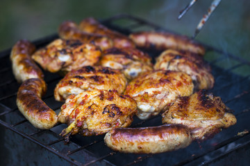 Chicken Sausages being grilled on an outdoor barbecue for that Special Smokey Outdoor Taste