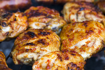 Chicken Sausages being grilled on an outdoor barbecue for that Special Smokey Outdoor Taste