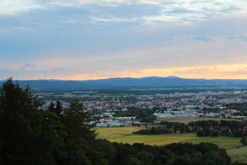 Panoramatic view on city Ceske Budejovice in sunset with trees