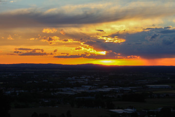 Panoramatic view on city Ceske Budejovice in sunset with orange sky