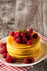 Fresh made delicious pancakes with berries, blackberries, raspberries, banana, honey and maple syrup. Healthy morning breakfast concept.