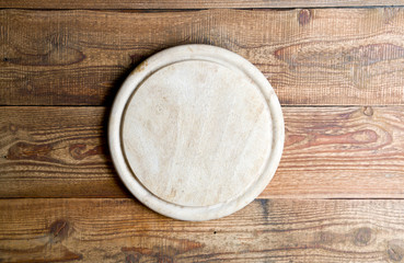 Kitchen board on the wooden background