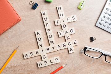 Conceptual media keywords on table with elements of game making crossword