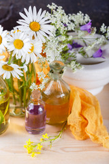 Obraz na płótnie Canvas Essential oils and wild flowers