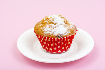 Sweet vanilla cupcakes on pastel pink background.