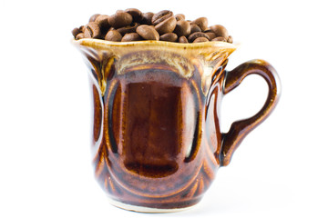 Coffee beans in a small cup on a white background. Isolated