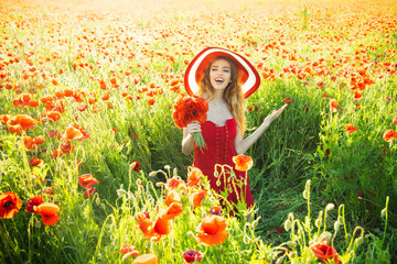 woman in field of poppy seed in retro hat