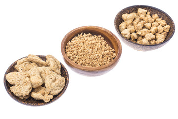 Set of wooden bowls with soy meat pieces.