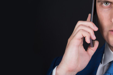 man half face talking on smartphone