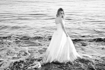 Fototapeta na wymiar Bride on a Beach Trash the Dress