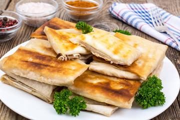 White plate  with envelopes of thin Armenian bread lavash fried 
