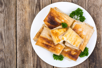 White plate  with envelopes of thin Armenian bread lavash fried 
