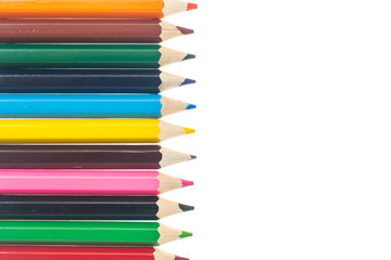 Line of colored pencils on white background