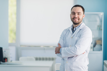 Fototapeta premium Young handsome doctor indoors at hospital office