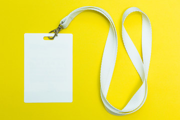 Name id card badge with cord on yellow background, empty space for text.